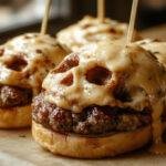 A plate featuring three creatively shaped cheeseburger skulls with melted cheese forming skull-like contours, garnished with fresh lettuce and sliced tomatoes, served on a dark wooden board with Halloween-themed decorations in the background for a festive look.