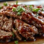A hearty meatloaf glazed with a shiny, caramel-colored brown sugar glaze, sliced to reveal a moist, tender interior with a rich, savory appearance. The loaf sits on a rustic platter, garnished with fresh herbs and accompanied by sides, with a glossy finish highlighting the sweet and savory combination.